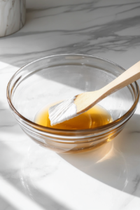 This image shows fresh apple chunks, walnuts, and raisins being gently folded into the cake batter, adding texture and flavor.