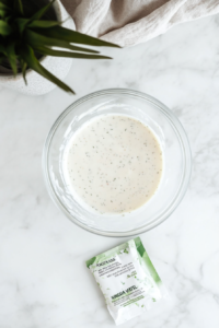 This image shows fresh ingredients such as mayonnaise, buttermilk, and seasoning measured and ready to be used for making a creamy Wingstop-style ranch dressing.