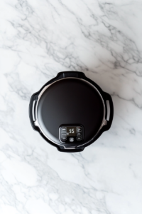 This image shows an Instant Pot set to pressure cook the chicken and wild rice, ensuring tender, flavorful results in a short time.