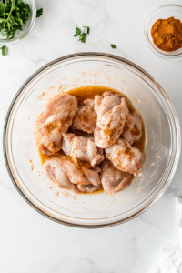 marinating-chicken-in-a-blend-of-tikka-spices-and-yogurt-for-deep-flavor
