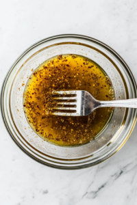 This image shows a top-down view of a bowl filled with a flavorful marinade being prepared to season the chicken for Tostadas de Pollo.