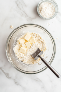 This image shows butter, sugar, and flour being combined to create a crumbly and flavorful streusel topping for the Irish Apple Cake.