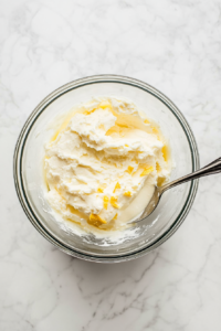 This image shows a creamy filling being made with cream cheese, sugar, and vanilla, adding a rich and slightly tangy sweetness to the Polish cheese babka.