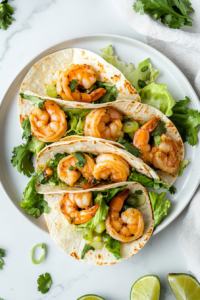 This image shows cilantro lime shrimp wraps beautifully plated, garnished with green onions and drizzled with cilantro garlic sauce for a vibrant and flavorful dish.
