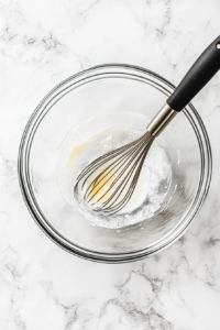 pouring-melted-butter-into-wet-ingredients-for-pancake-batter