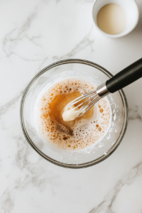 pouring-melted-butter-into-wet-ingredients-for-pancake-batter-2