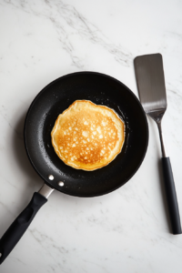 pouring-pancake-batter-onto-a-hot-skillet-for-buttermilk-pancakes