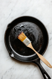 This image shows a top-down view of a griddle pan being heated, getting ready for perfectly cooking the marinated chicken.