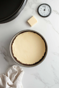 This image shows a baking pan being greased and prepped, ensuring the Irish Apple Cake bakes evenly with a smooth release.