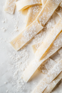 This image shows tender cooked chicken being shredded into small, bite-sized pieces for the Chicken and Dumplings.