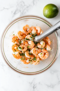 This image shows the diced shrimp marinating in a zesty citrus blend, allowing the flavors to deepen and enhance the freshness of the dish.