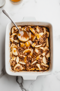 spreading-apple-filling-and-caramel-over-dough