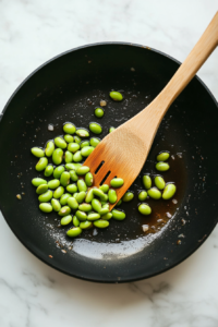This image shows edamame being cooked to a vibrant green, adding a nutritious and delicious side to the chicken katsu rice bowl.