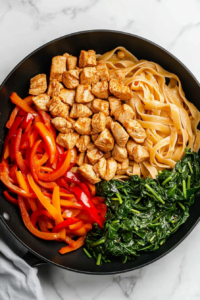 tossing-cooked-ingredients-together-in-a-skillet-for-chicken-tequila-fettuccine