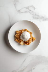 warm-apple-crisp-being-served-with-a-spoon-from-the-baking-dish-into-a-bowl