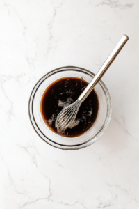 This image shows freshly chopped bell peppers, carrots, green onions, garlic, and ginger, prepared for stir-frying.