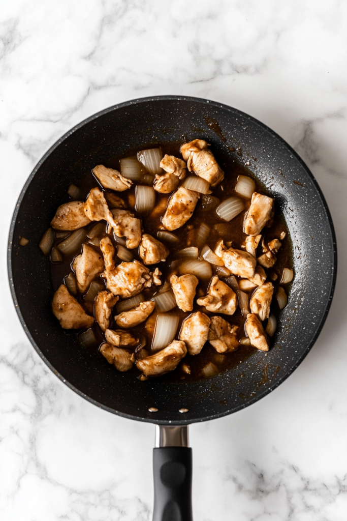vinaigrette-poured-over-cooked-chicken-in-black-skillet