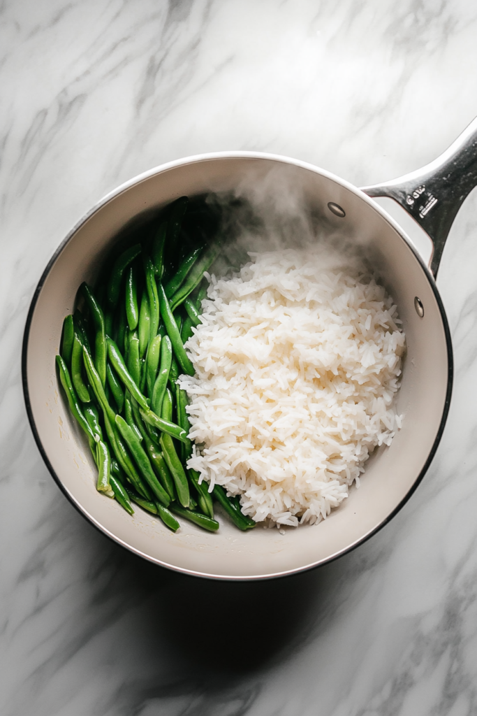 white-saucepan-steaming-rice-and-veggies-on-white-marble