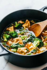 Adding-Handmade-Wontons-and-Fresh-Vegetables-to-the-Boiling-Broth-9879675-683x1024-5328441