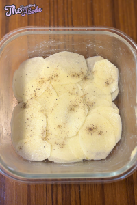 Arrange half of the sliced potatoes