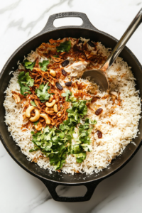 This image shows layers of aromatic basmati rice, succulent marinated chicken, saffron-infused milk, and crispy fried onions being carefully assembled for the final dum cooking process of Chicken Dum Biryani.