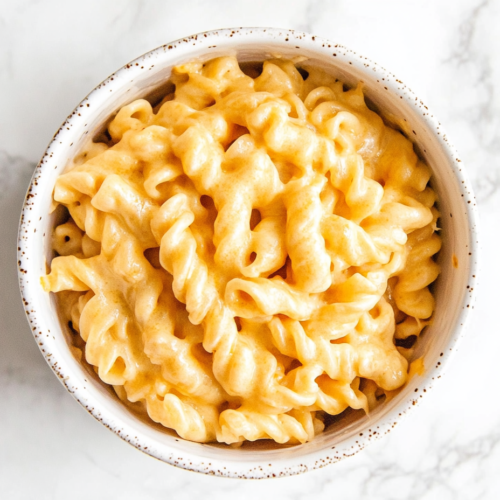 boston-market-mac-and-cheese-served-in-a-white-round-bowl-coated-in-creamy-melted-cheese