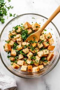 combining-the-sauteed-onions-and-celery-with-the-bread-crumbs-for-the-stuffing-mixture