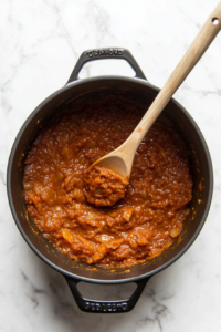 This image shows a freshly blended Goan curry paste being sautéed in a pan, deepening its rich flavors and aromatic spices for an authentic taste.