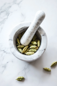 crushing-cardamom-pods-for-flavorful-sooji-halwa-recipe