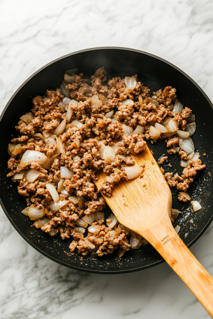 draining-grease-and-returning-sausage-to-the-skillet-for-further-cooking-7673437-683x1024