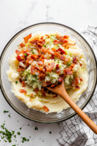 folding-crispy-bacon-and-sauteed-vegetables-into-the-mashed-potatoes