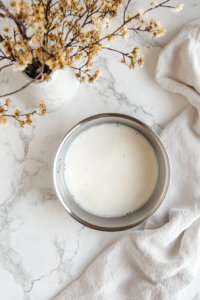This image shows milk being gently heated in a pan, preparing it for the custard mixture.