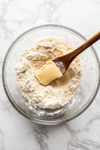 This image shows hands kneading the dough until it becomes soft and pliable, ensuring a smooth texture for the Gulab Jamun balls.