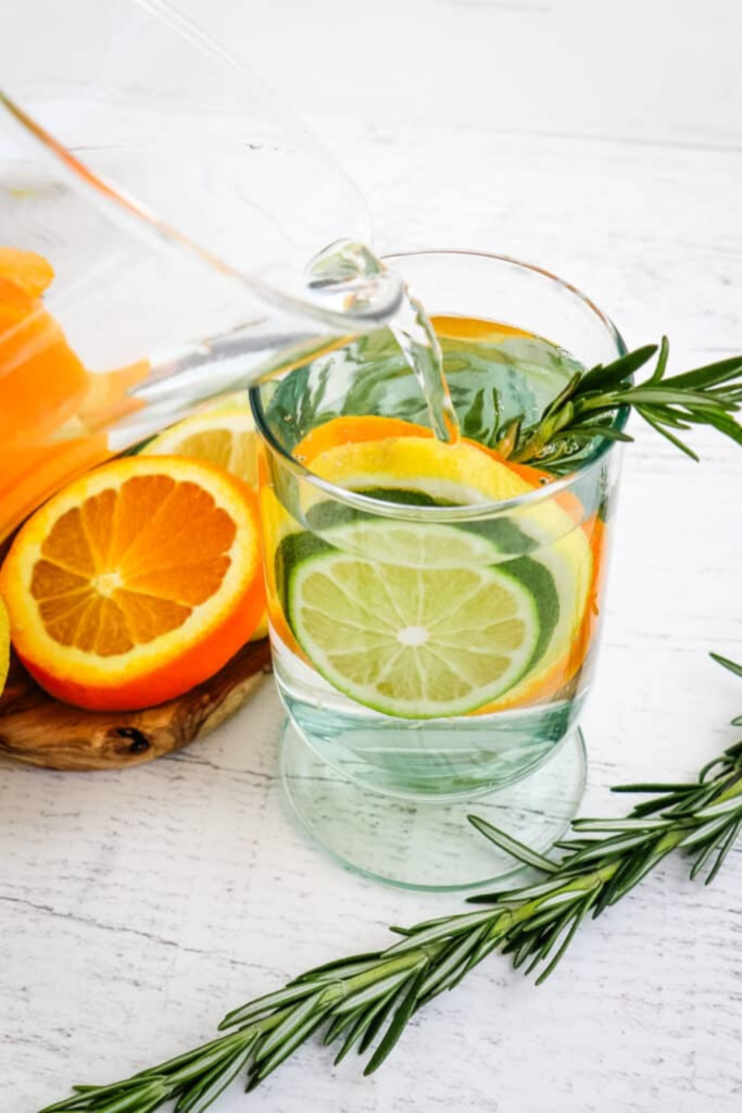 lemon-and-roseberry-water-with-floating-herbs-and-citrus-slices-in-glass-jar
