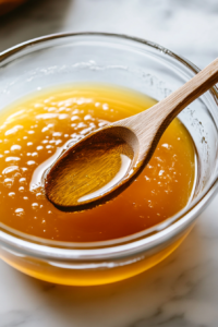 This image shows oil, salt, and flour being mixed into the activated yeast mixture, forming the dough for the sweet Amish bread.