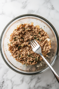 mixing-sausage-filling-in-bowl-top-down-view