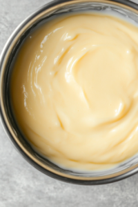 This image shows the custard being placed in the refrigerator to chill and set.