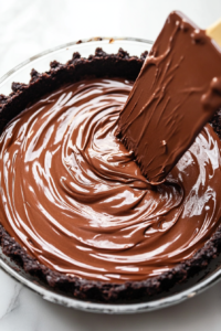pouring-the-luxurious-chocolate-cheesecake-filling-into-the-pie-crust