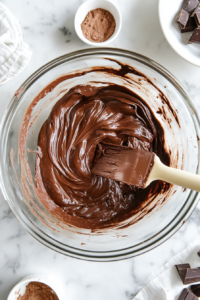 scraping-down-the-mixing-bowl-for-a-smooth-even-cheesecake-filling