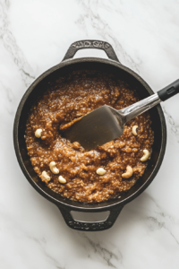 This image shows semolina absorbing the sugar syrup, swelling and thickening as it cooks into a rich and creamy Sooji Halwa.