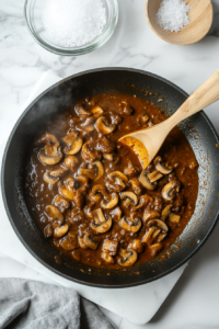 This image shows the Mushroom Masala simmering gently, allowing the mushrooms to absorb the deep flavors of the rich, spiced curry.