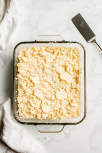 spreading-crust-mixture-evenly-in-a-baking-dish-and-preparing-for-the-oven