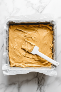 spreading-the-cake-batter-evenly-into-the-baking-pan
