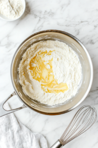 stirring-flour-into-melted-butter-to-create-a-thick-roux-for-cheese-sauce