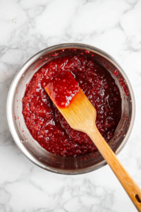 stirring-the-strawberry-mixture-gently-over-low-heat