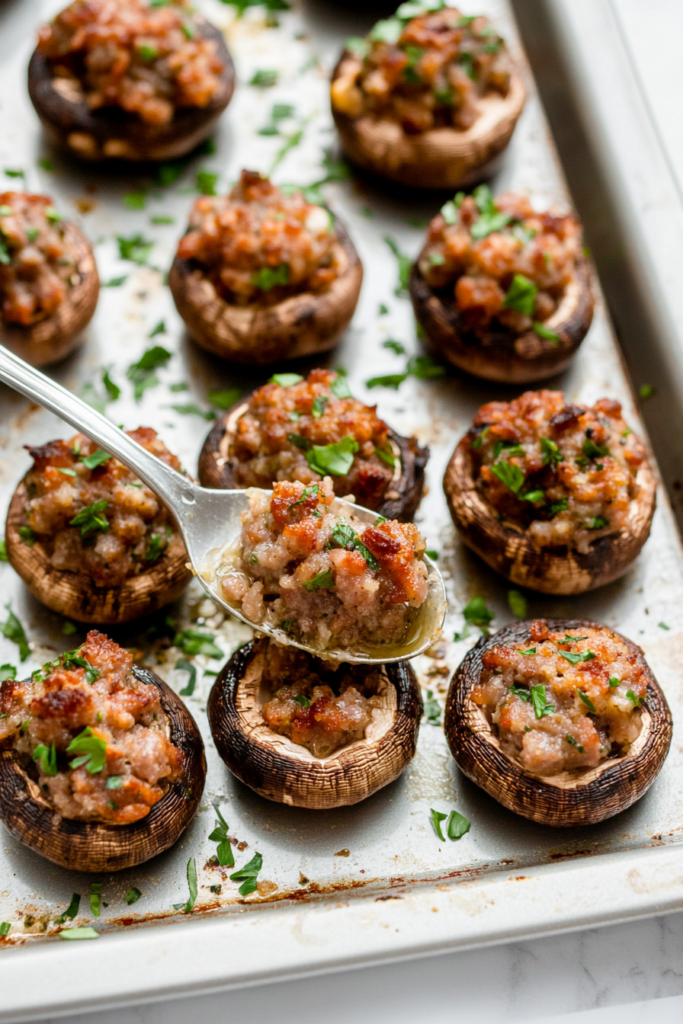 stuffing-the-mushrooms-with-the-savory-sausage-mixture-3940323-683x1024
