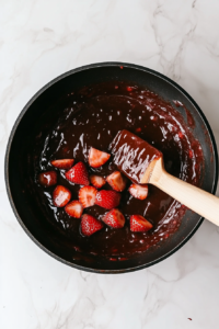 The strawberry mixture bubbling in a pot as it thickens to the perfect consistency.