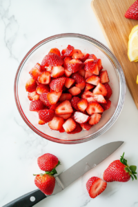 washing-and-prepping-fresh-strawberries-in-a-colander-under-running-water
