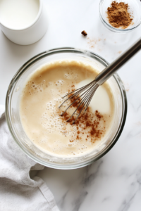 whisking-the-wet-ingredients-to-create-a-rich-and-creamy-custard-mixture