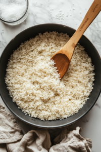 Cold water and a pinch of salt are added to the toasted Bomba rice, setting the stage for it to absorb the flavors and cook to perfection.